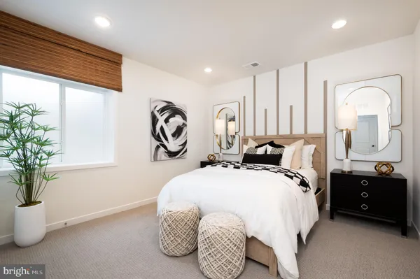 a bed room with a bed and a potted plant