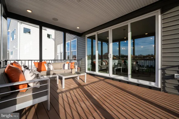 a balcony with wooden floor and glass door
