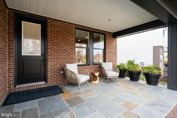 a building outdoor space with patio furniture and potted plants