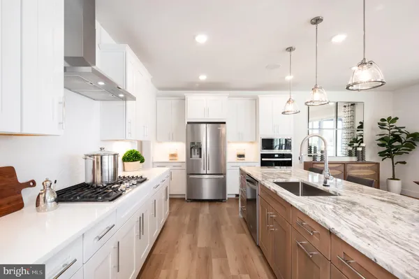 a kitchen with a sink stainless steel appliances and counter space
