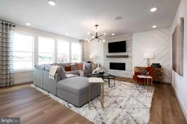 a living room with furniture fireplace and flat screen tv