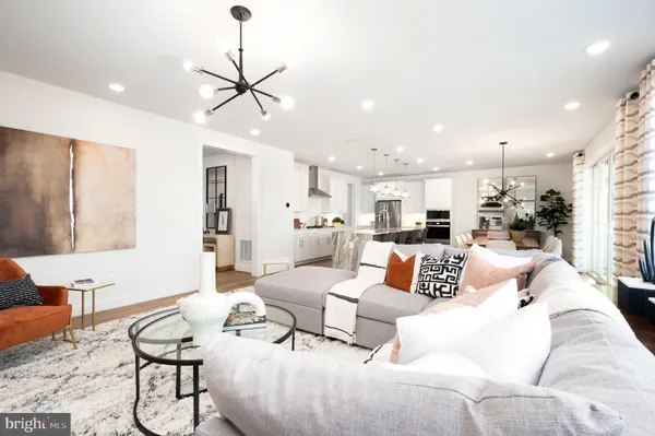 a living room with furniture and kitchen view