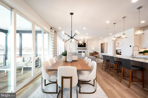 a dining room with furniture a chandelier and wooden floor
