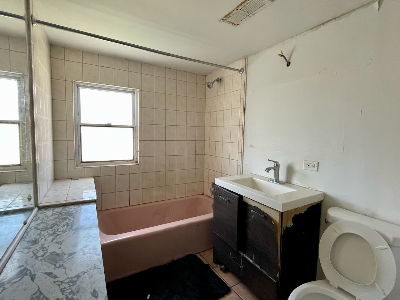 7304 West 57th Street Summit, IL 60501 - Photo 25 of 32 a bathroom with a sink a toilet a mirror and bathtub