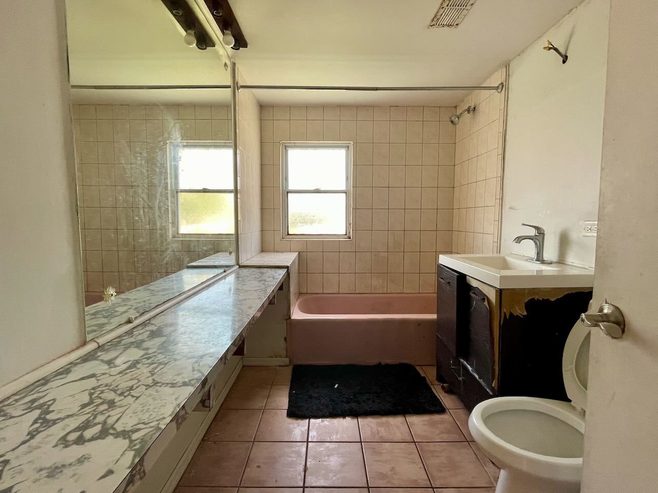 7304 West 57th Street Summit, IL 60501 - Photo 26 of 32 a bathroom with a bathtub a sink and a shower