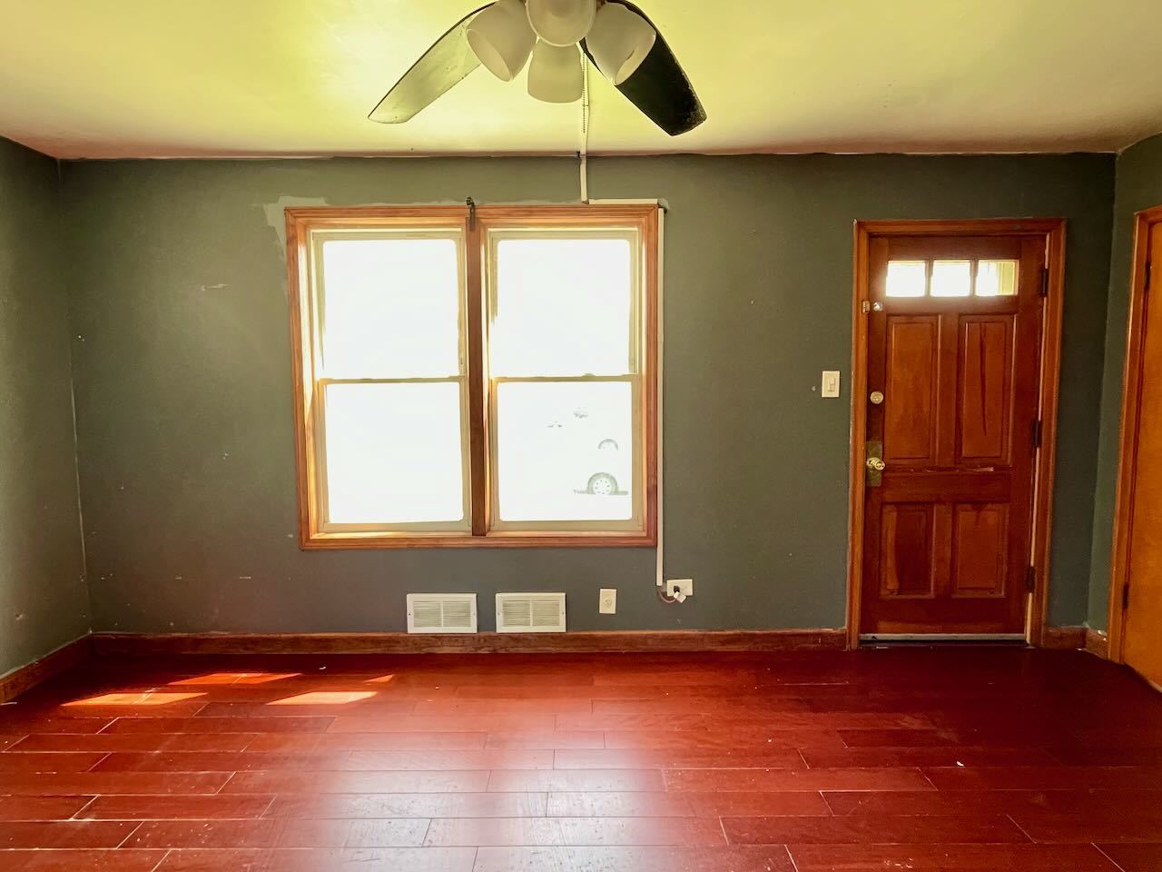 7304 West 57th Street Summit, IL 60501 - Photo 3 of 32 an empty room with wooden floor and windows