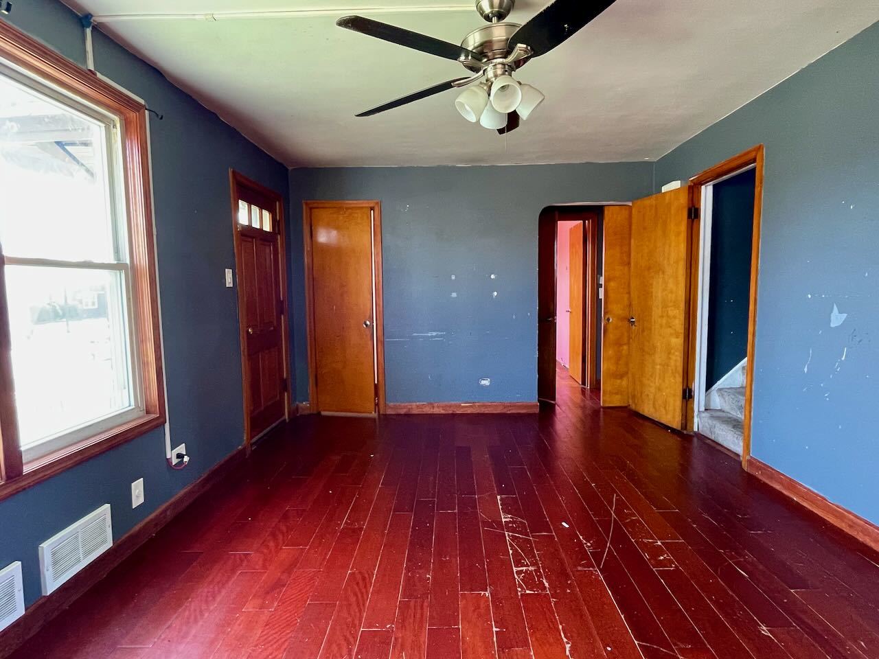 7304 West 57th Street Summit, IL 60501 - Photo 4 of 32 a view of an empty room with wooden floor and a window