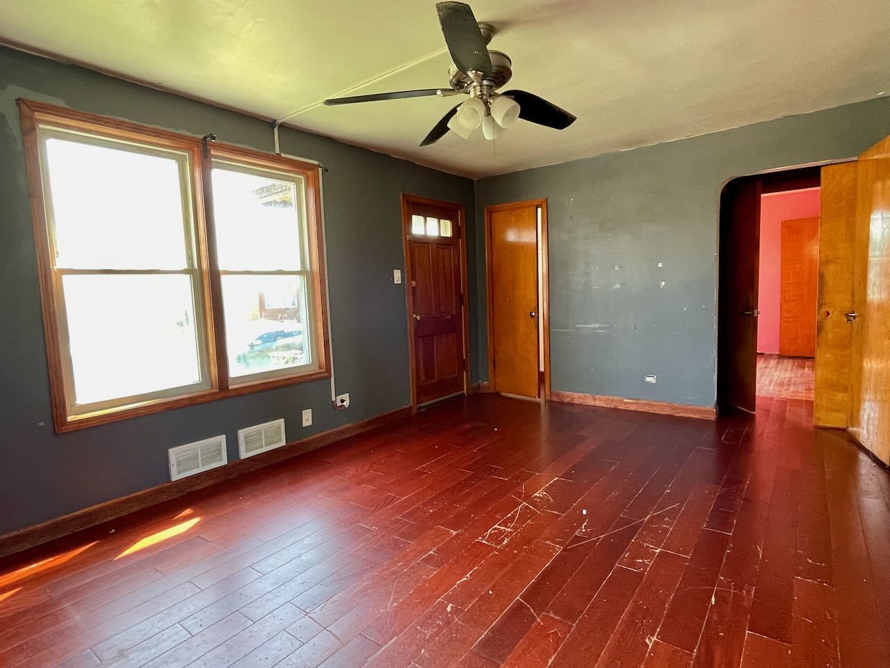 7304 West 57th Street Summit, IL 60501 - Photo 5 of 32 an empty room with wooden floor and windows