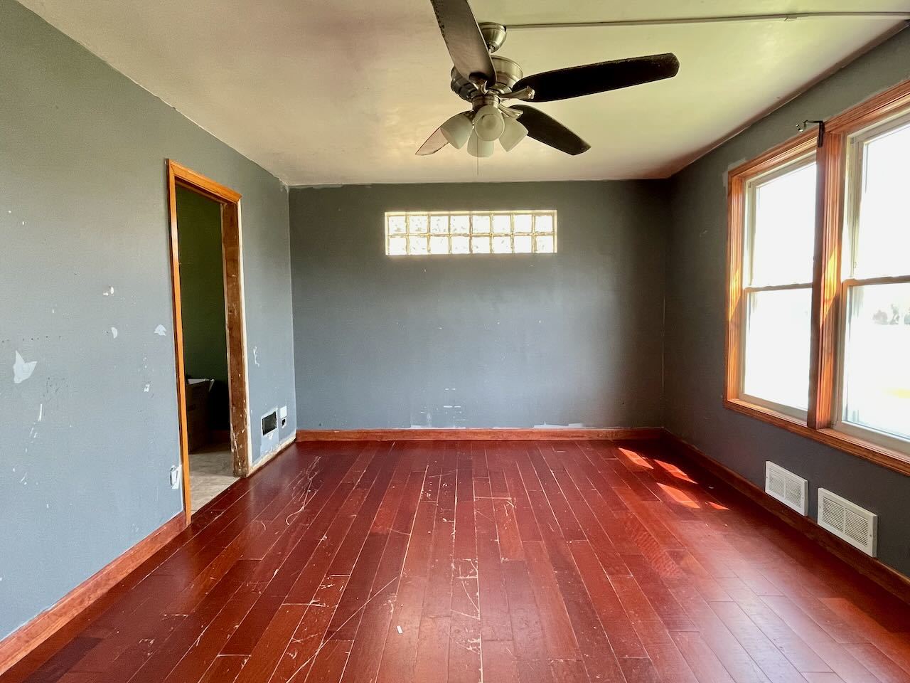 7304 West 57th Street Summit, IL 60501 - Photo 7 of 32 wooden floor in an empty room with a window