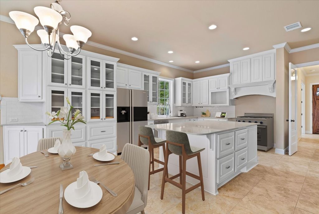 3006 Washington Square Austin, TX 78705 - Photo 11 of 40 a large kitchen with kitchen island granite countertop a large center island a sink stainless steel appliances and cabinets