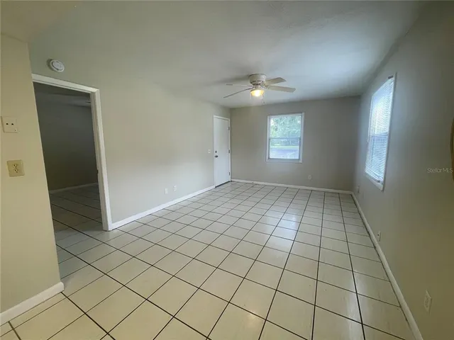 an empty room with windows and closet