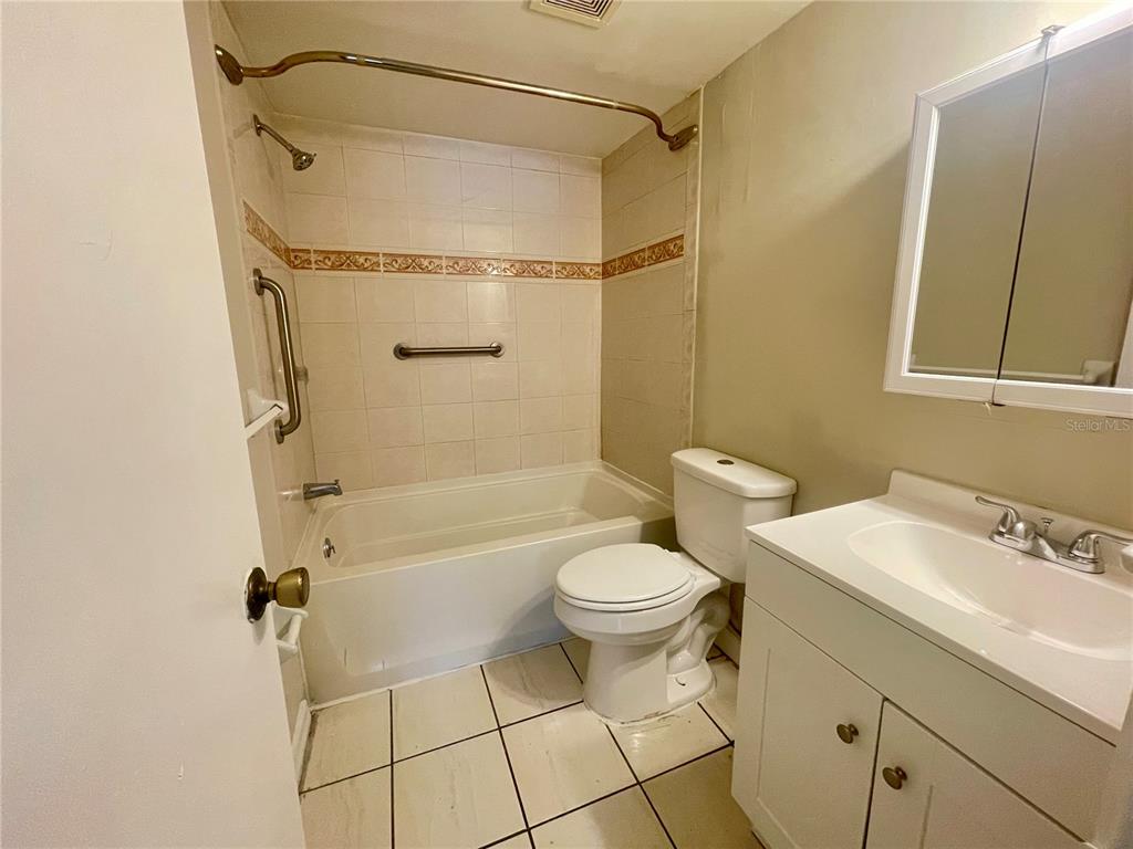 5119 Curry Ford Road, Unit 1 Orlando, FL 32812 - Photo 7 of 10 a bathroom with a sink toilet and shower