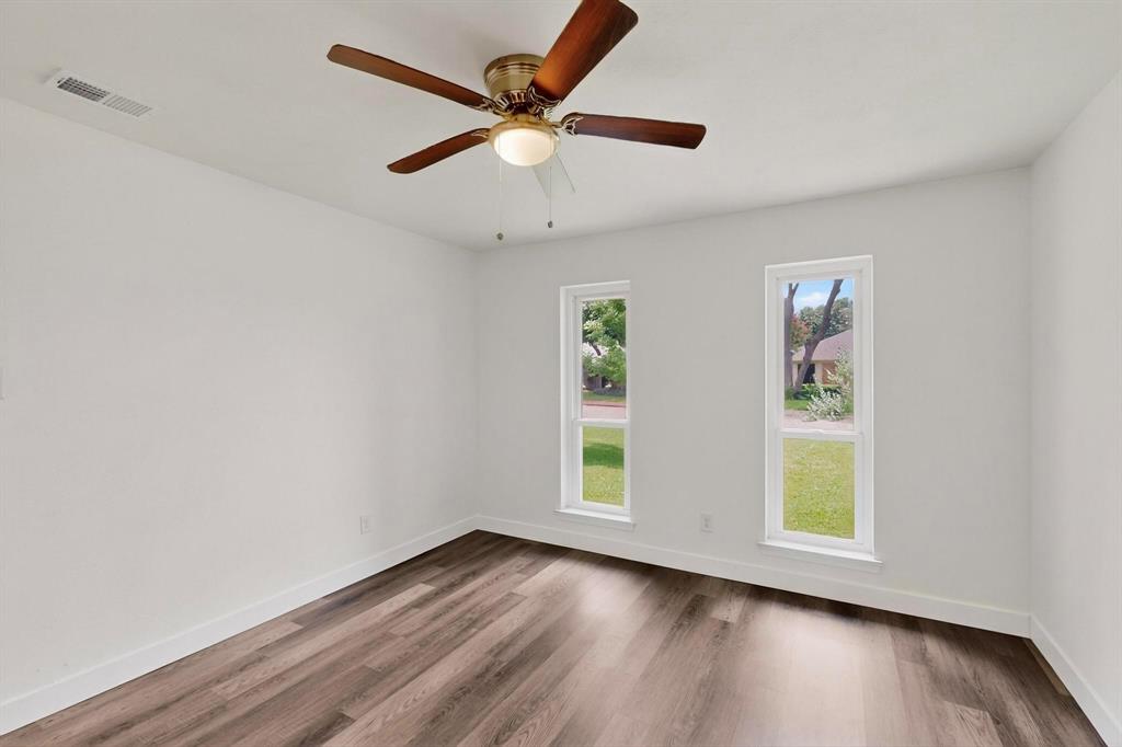 4857 Fallon Place Dallas, TX 75227 - Photo 16 of 19 Empty room with wood finished floors and baseboards