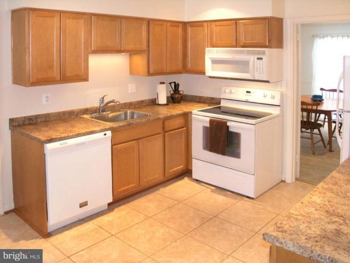 12701 Pinecrest Road Herndon, VA 20171 - Photo 14 of 30 a kitchen with a sink stove and cabinets