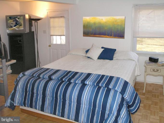 12701 Pinecrest Road Herndon, VA 20171 - Photo 16 of 30 a bedroom with a bed a mirror and dresser