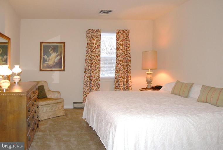 12701 Pinecrest Road Herndon, VA 20171 - Photo 18 of 30 a bedroom with a bed and a couch
