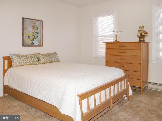 12701 Pinecrest Road Herndon, VA 20171 - Photo 20 of 30 a bedroom with a bed and a painting on the wall
