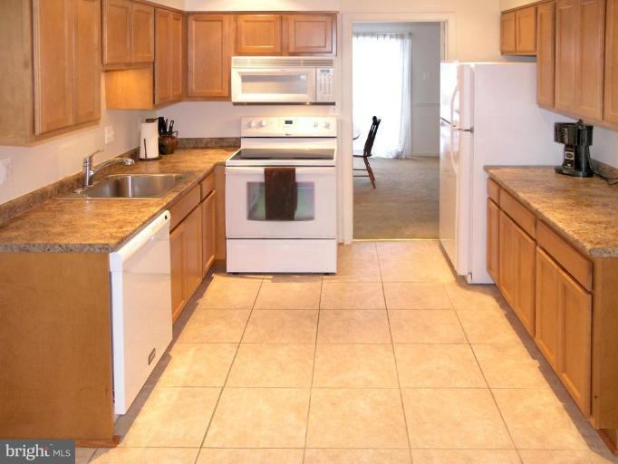 12701 Pinecrest Road Herndon, VA 20171 - Photo 3 of 30 a kitchen with stainless steel appliances granite countertop a sink stove and refrigerator