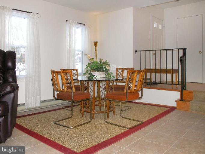 12701 Pinecrest Road Herndon, VA 20171 - Photo 6 of 30 a dining room with furniture and wooden floor