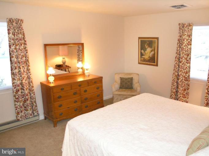 12701 Pinecrest Road Herndon, VA 20171 - Photo 7 of 30 a bedroom with a bed and a cabinets