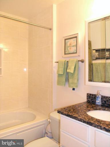 12701 Pinecrest Road Herndon, VA 20171 - Photo 9 of 30 a bathroom with a granite countertop sink and a mirror