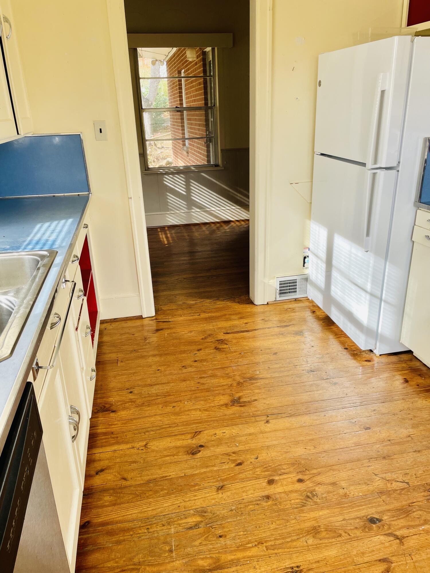 1917 Langdon Road Southwest Roanoke, VA 24015 - Photo 13 of 54 a view of an empty room with wooden floor and a window