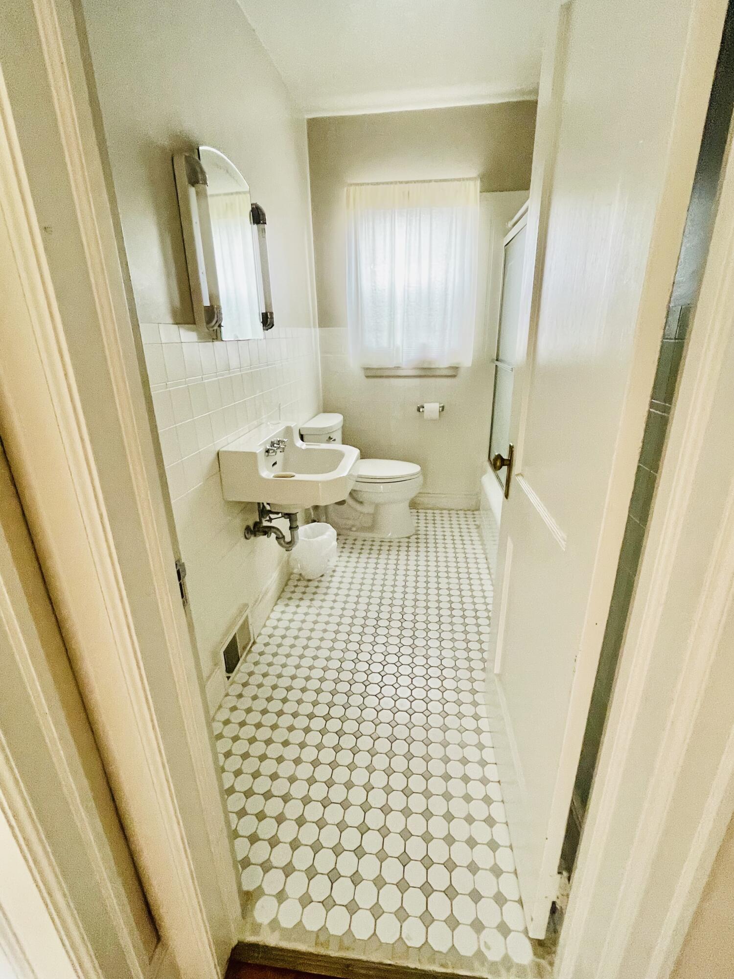 1917 Langdon Road Southwest Roanoke, VA 24015 - Photo 19 of 54 a bathroom with a sink a mirror and shower