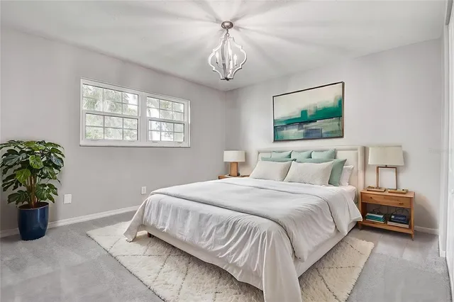 a bedroom with a bed and a chandelier