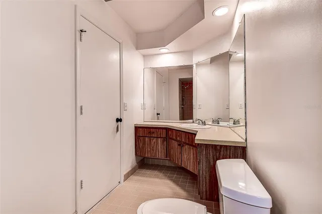 a white toilet sitting next to a bath tub