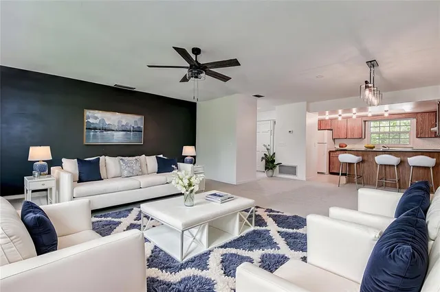 a bedroom with a large bed and a potted plant