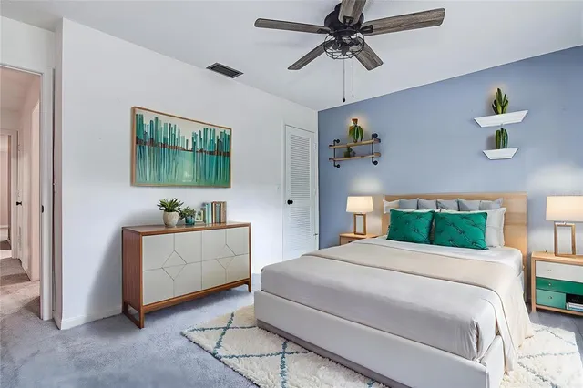 a bathroom with a granite countertop toilet sink and mirror