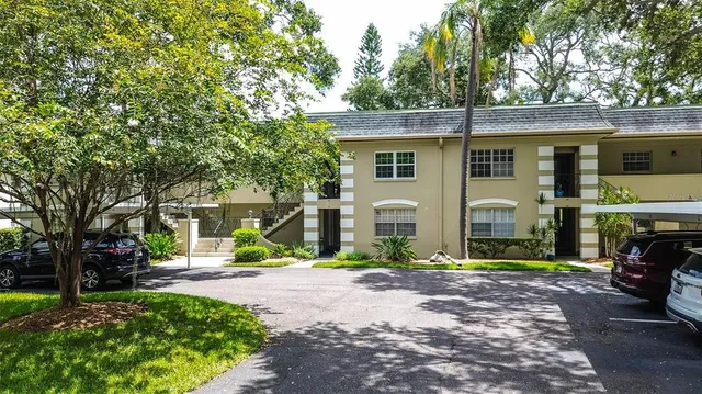 an aerial view of residential houses with outdoor space and trees