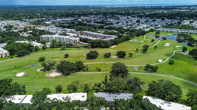 an aerial view of residential houses with outdoor space and river