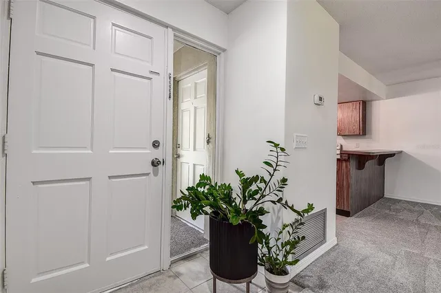 a view of a hallway with potted plants