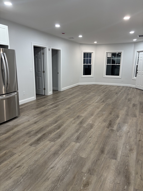 943 County Street, Unit 2 FRONT Fall River, MA 02723 - Photo 2 of 8 an empty room with wooden floor and windows