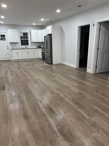 a view of kitchen with refrigerator and window