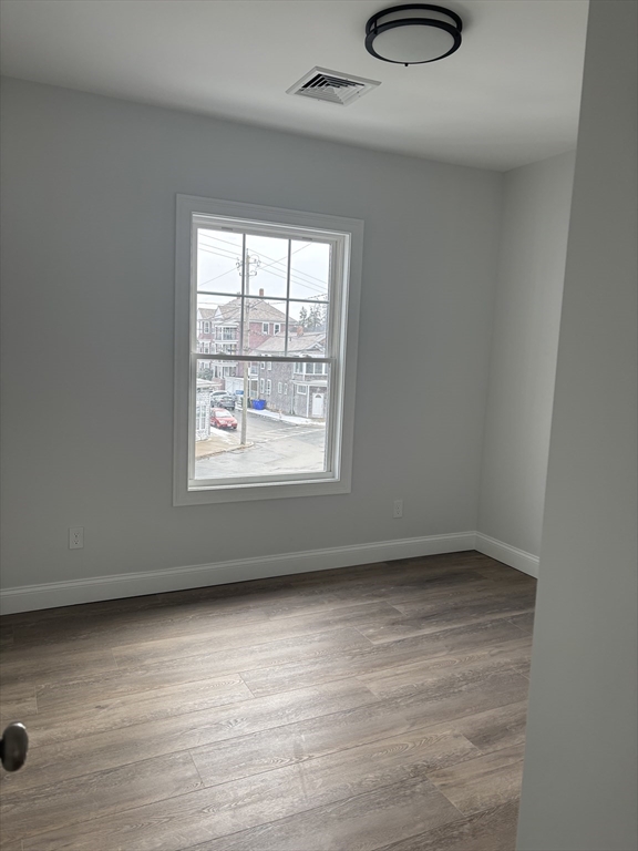 943 County Street, Unit 2 FRONT Fall River, MA 02723 - Photo 5 of 8 an empty room with a empty space and a window