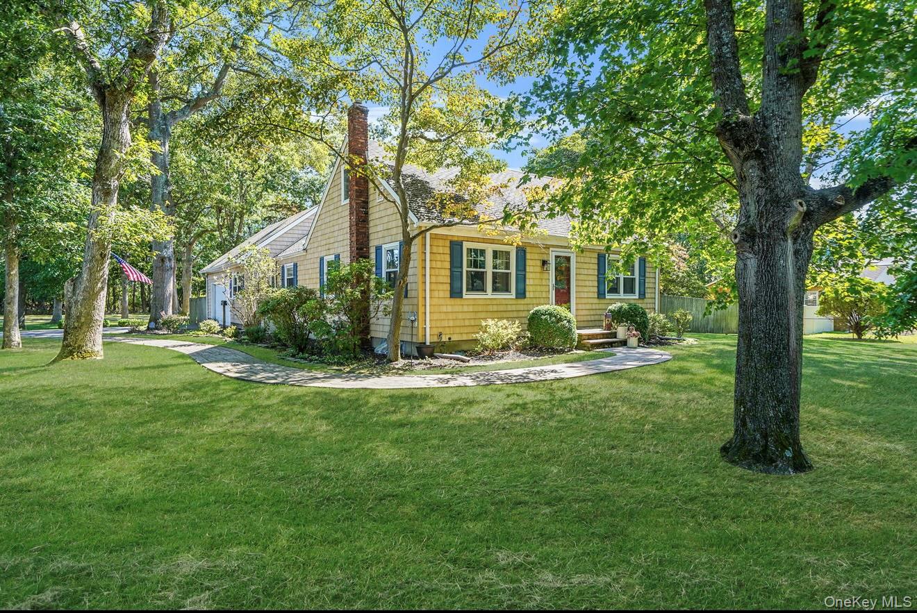 a front view of house with yard and green space