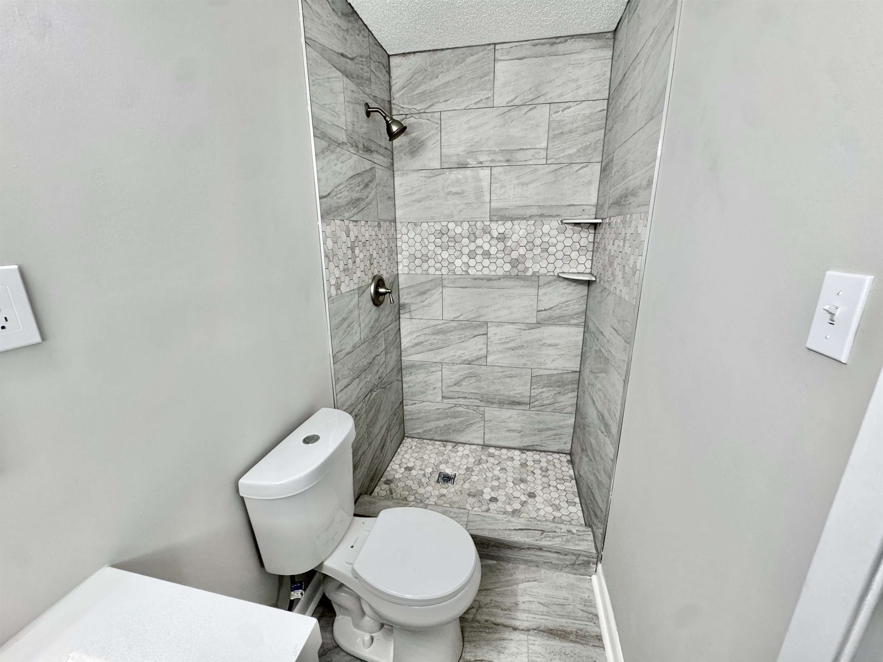 5095 Bowie Road Memphis, TN 38109 - Photo 16 of 25 Full bath featuring a stall shower and light wood finished floors