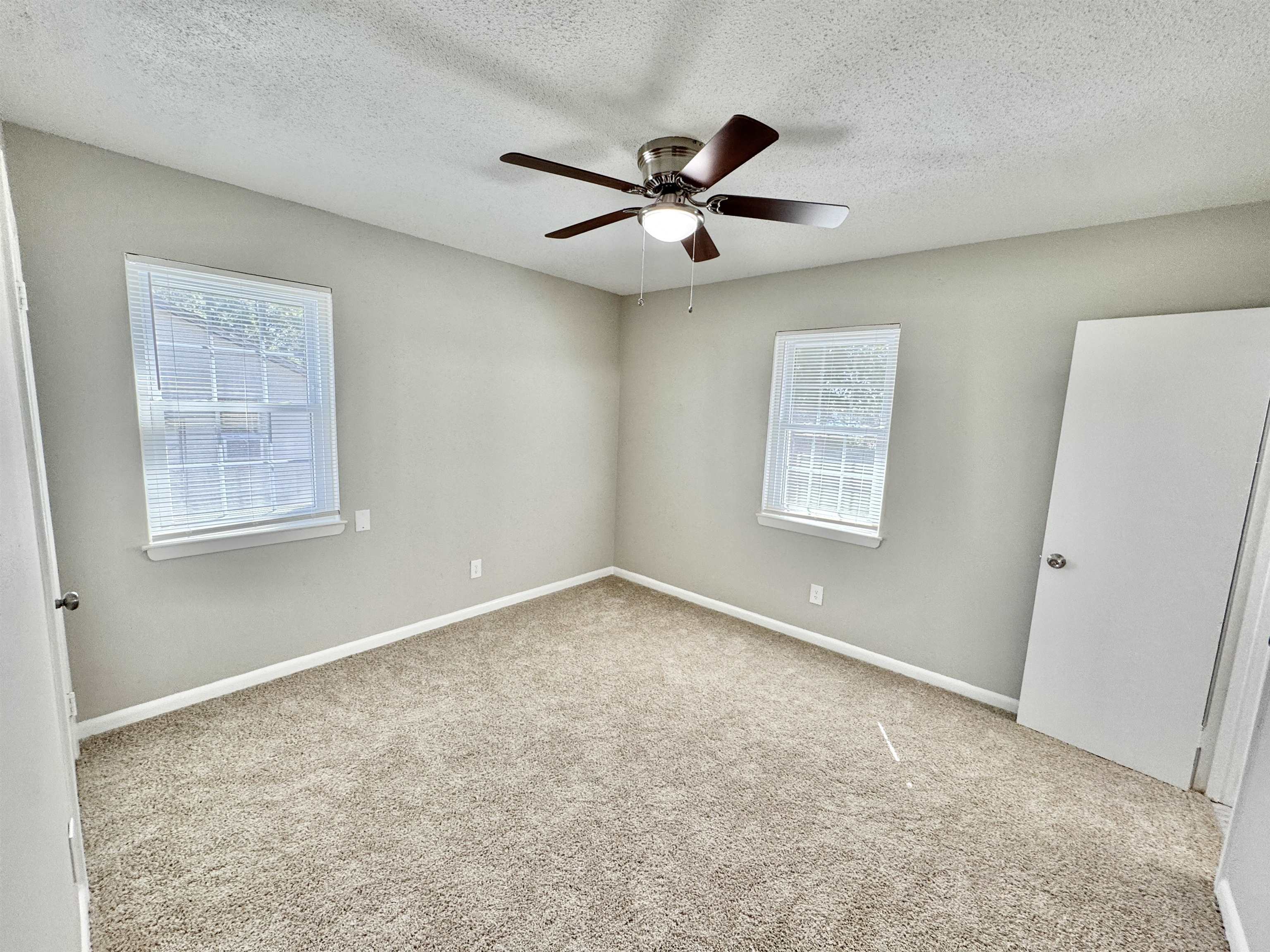 5095 Bowie Road Memphis, TN 38109 - Photo 17 of 25 Bedroom with neutral carpet, healthy amount of natural light, a textured ceiling, and a ceiling fan