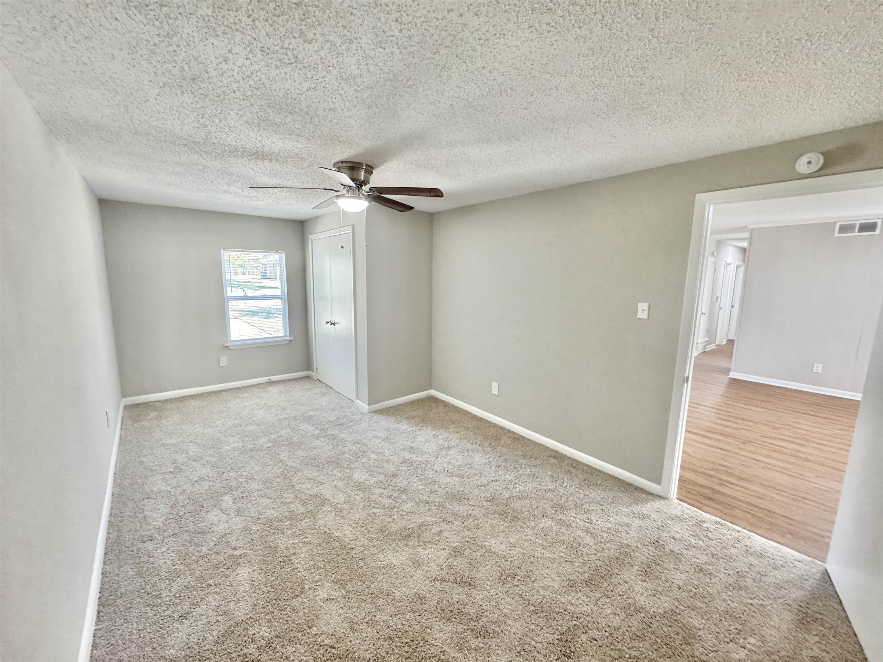 5095 Bowie Road Memphis, TN 38109 - Photo 20 of 25 Unfurnished bedroom featuring light colored carpet, a textured ceiling, and ceiling fan