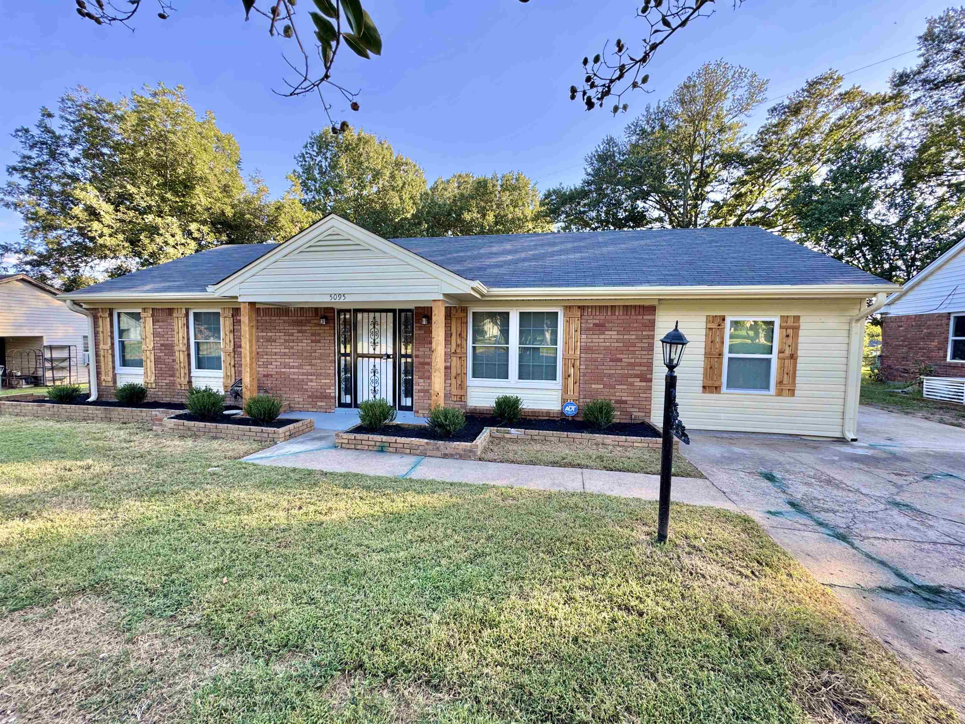5095 Bowie Road Memphis, TN 38109 - Photo 3 of 25 Single story home featuring a front lawn, brick siding, and roof with shingles