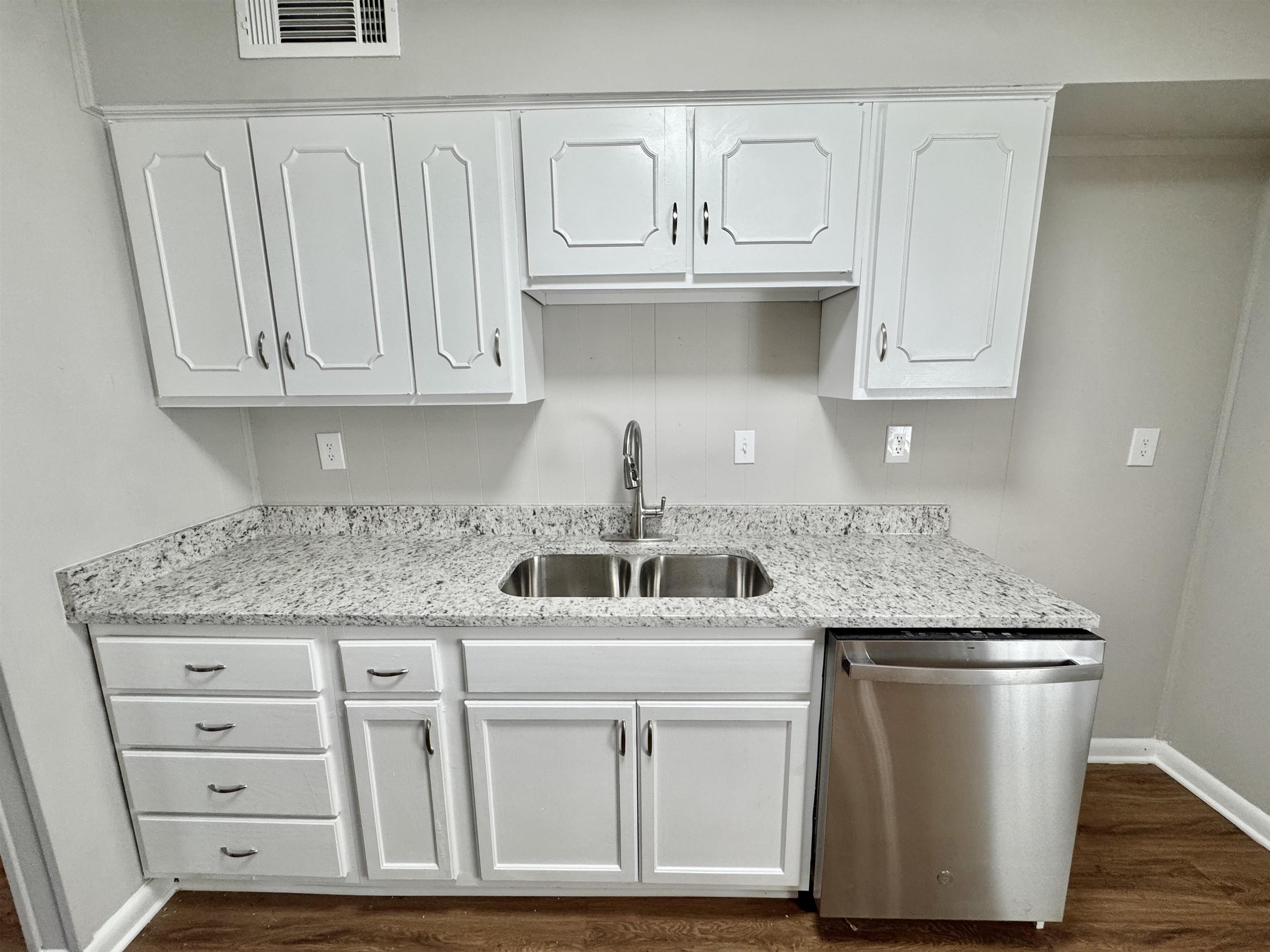 5095 Bowie Road Memphis, TN 38109 - Photo 6 of 25 Kitchen featuring white cabinetry, dishwasher, and dark wood-style flooring