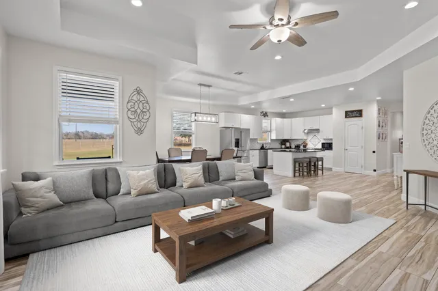 a spacious bedroom with a large bed and a chandelier