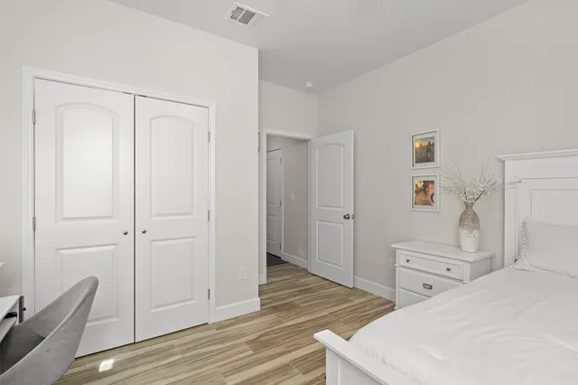 a bedroom with a bed and with windows