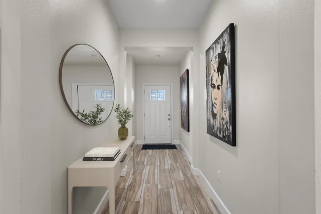 stairs of a house with wooden floor mirror and windows