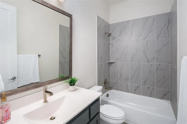 a bathroom with a sink a toilet and bathtub