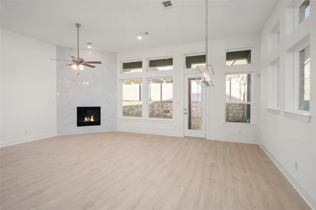 a view of an empty room with a fireplace and a window