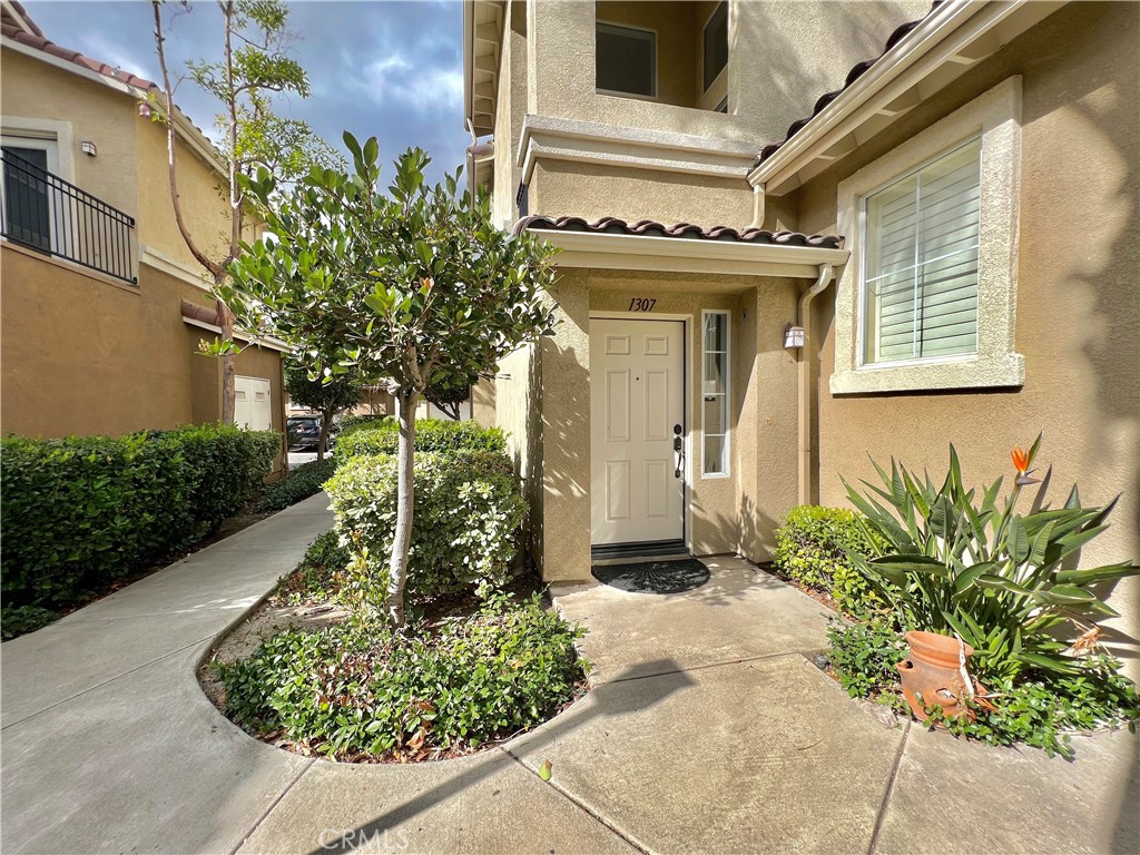 1307 Elmhurst Irvine, CA 92618 - Photo 13 of 14 a front view of a house with garden