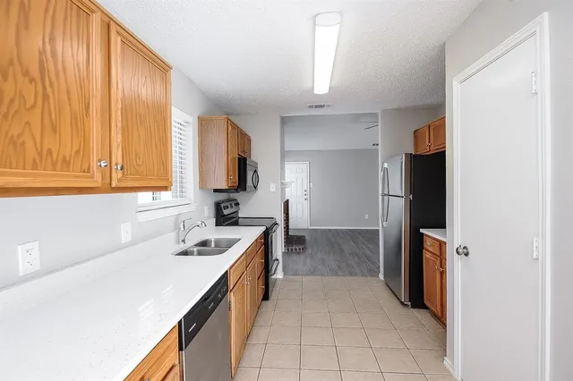 a kitchen with a sink cabinets and appliances